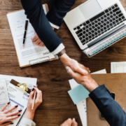 Businesspeople shaking hands across table Businesspeople shaking hands across table