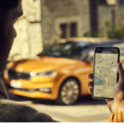 Person checking phone on street corner Person checking phone on street corner